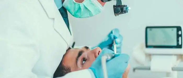 A man getting his teeth checked during Root Canal Treatment.